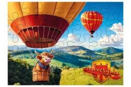 Puzzle 100 pièces souvenir Auvergne illustré d'une vache en montgolfière